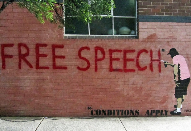 "Free Speech" spraypainted on a brick wall. 
